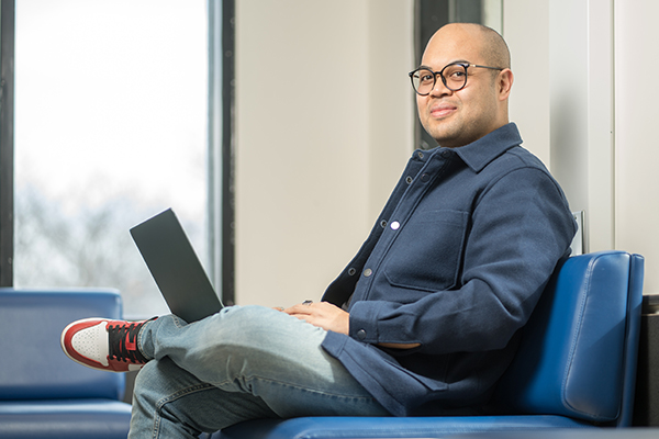 Étudiant assis avec son ordinateur portable